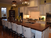 Walnut wood countertop with 2 undermount farm sinks. This wide plank walnut kitchen island top has a large cove and bead edge profile. Dimension are 1.75” thick x 50” x 188” . Expanded corners on both ends of top. Permanent finish. Installed just outside of Charlotte in Weddington , NC.